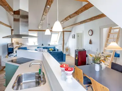 a kitchen and living room with wooden beams at 4 star holiday home in Thisted-By Traum in Thisted