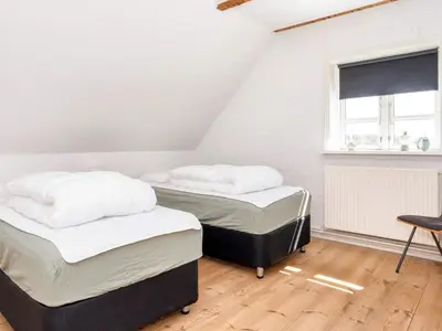 two twin beds in a room with a window at 4 star holiday home in Thisted-By Traum in Thisted