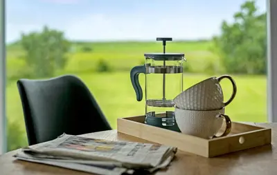 a glass blender on a wooden table with a window at Nice Home In Thyholm With Wifi in Thyholm