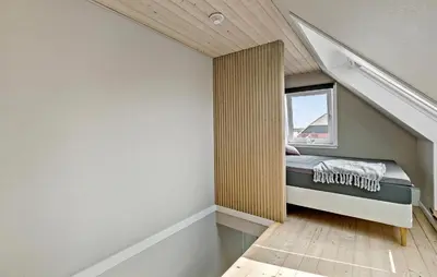 a small bedroom with a bed and a window at Nice Home In Thyholm With Wifi in Thyholm