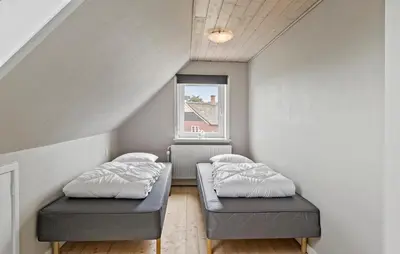 two beds in a small room with a window at Nice Home In Thyholm With Wifi in Thyholm