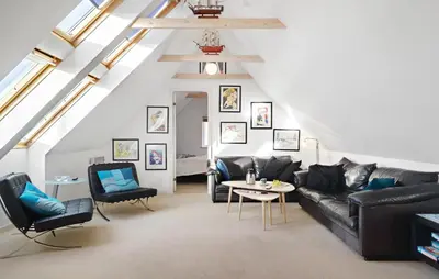 a living room with a black leather couch and chairs at Amazing Home In Harboøre With Kitchen in Harboør