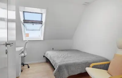 a bedroom with a bed and a desk and a window at Gorgeous Home In Løgstør in Løgstør