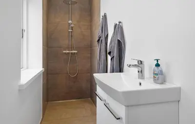 a bathroom with a sink and a shower at Gorgeous Home In Løgstør in Løgstør