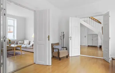 a white living room with a couch and a stairway at Gorgeous Home In Løgstør in Løgstør