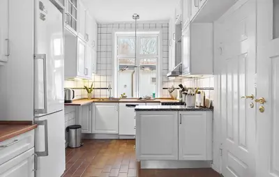 a white kitchen with white cabinets and a window at Gorgeous Home In Løgstør in Løgstør