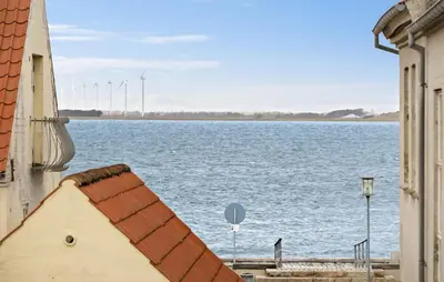 a view of a large body of water with wind turbines at Gorgeous Home In Løgstør in Løgstør