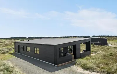 a black house in the middle of a field at Gorgeous Home In Thisted With Wifi in Thisted