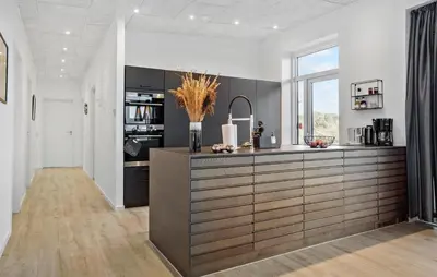 a large kitchen with a large wooden counter top at Gorgeous Home In Thisted With Wifi in Thisted