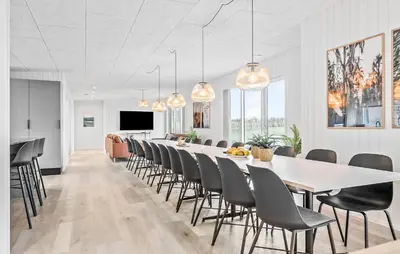 a dining room with a long table and chairs at Stunning Home In Løgstrup With Kitchen in Løgstrup