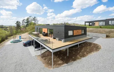 a house on a hill with a deck at Stunning Home In Løgstrup With Kitchen in Løgstrup