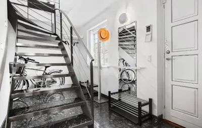 a staircase in a room with bikes on the wall at Amazing Home In Blokhus With Kitchen in Blokhus