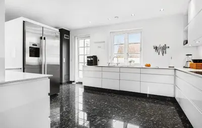a white kitchen with a sink and a refrigerator at Amazing Home In Blokhus With Kitchen in Blokhus
