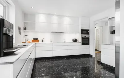 a white kitchen with white cabinets and black appliances at Amazing Home In Blokhus With Kitchen in Blokhus