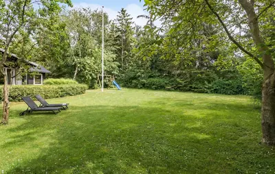 a swing in a yard with a playground at 3 Bedroom Pet Friendly Home In Højslev in Højslev