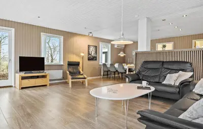a living room with a couch and a table at 3 Bedroom Pet Friendly Home In Højslev in Højslev