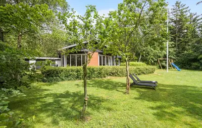 a park bench in a yard with a playground at 3 Bedroom Pet Friendly Home In Højslev in Højslev
