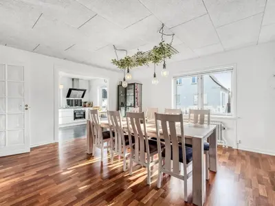 a kitchen and dining room with a table and chairs at Holiday Home Ullakarin - 200m from the sea by Interhome in Thyborøn