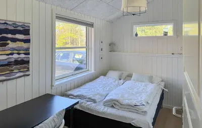 a bed in a room with a table and a window at 3 Bedroom Cozy Home In Thisted in Thisted