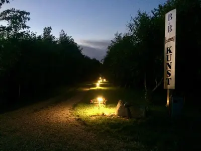 a lit up road with a sign on the side at pallisgaard B&B in Struer