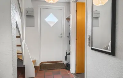 a hallway with a door and a mirror at 2 Bedroom Nice Apartment In Lemvig in Lemvig