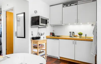 a kitchen with white cabinets and a microwave at 2 Bedroom Nice Apartment In Lemvig in Lemvig