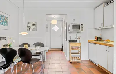 a kitchen with a table and chairs in a room at 2 Bedroom Nice Apartment In Lemvig in Lemvig