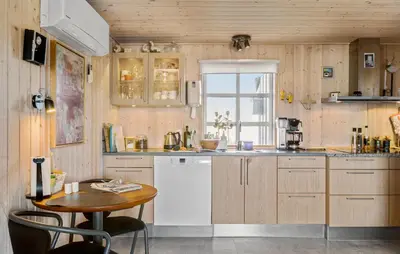 a kitchen with a white refrigerator and a table at 4 Bedroom Beautiful Home In Pandrup in Pandrup