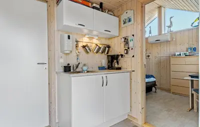 a kitchen with white cabinets and a sink at 4 Bedroom Beautiful Home In Pandrup in Pandrup
