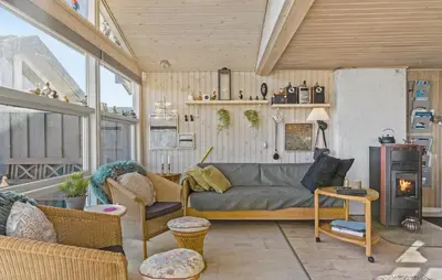 a living room with a couch and a fireplace at 4 Bedroom Beautiful Home In Pandrup in Pandrup
