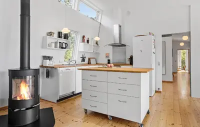 a kitchen with a fireplace in the middle of it at Nice Home In Hurup Thy With Wifi in Sindrup