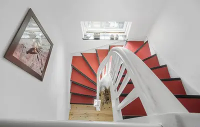 a staircase with a red and white stair case at 1 Bedroom Nice Apartment In Thyborøn in Thyborøn