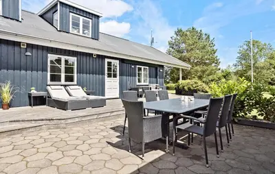 a patio with a table and chairs and a house at 3 Bedroom Pet Friendly Home In Højslev in Højslev