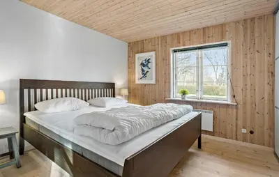 a bedroom with a large bed and a window at 3 Bedroom Pet Friendly Home In Højslev in Højslev
