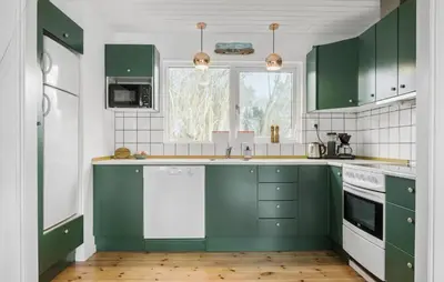 a kitchen with green cabinets and white appliances at 3 Bedroom Awesome Home In Vestervig in Vestervig