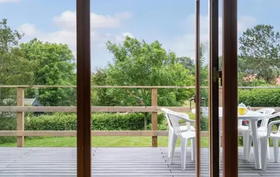 a patio with a table and chairs on a deck at 3 Bedroom Stunning Home In Hurup Thy in Doverodde