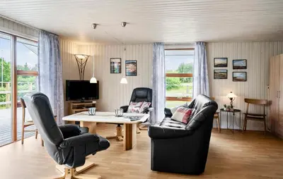 a living room with two chairs and a table at 3 Bedroom Stunning Home In Hurup Thy in Doverodde