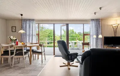 a living room with a table and a dining room at 3 Bedroom Stunning Home In Hurup Thy in Doverodde