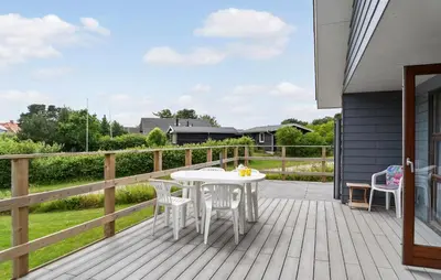 a white table and chairs on a wooden deck at 3 Bedroom Stunning Home In Hurup Thy in Doverodde