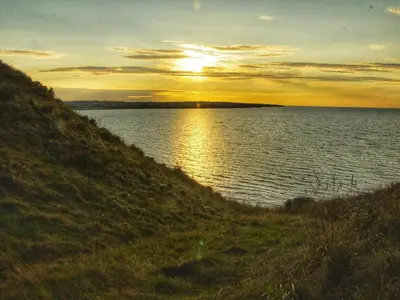 a sunset over a large body of water at 6 person holiday home in Struer-By Traum in Struer