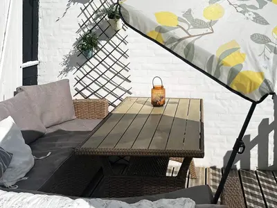 a picnic table with an umbrella on a patio at 6 person holiday home in Vestervig-By Traum in Vestervig