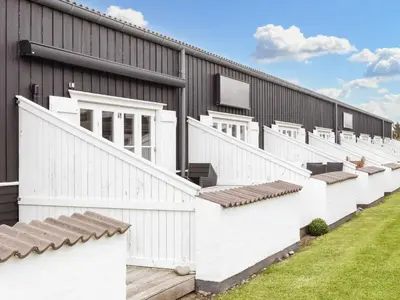 a row of white fences on the side of a building at 6 person holiday home in Vestervig-By Traum in Vestervig