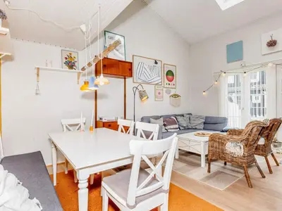 a dining room and living room with a table and chairs at 6 person holiday home in Vestervig-By Traum in Vestervig