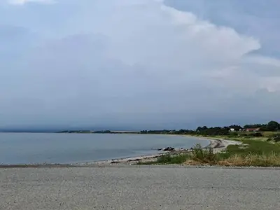 an empty road next to a body of water at 5 person holiday home in Vesløs-By Traum in Øsløs