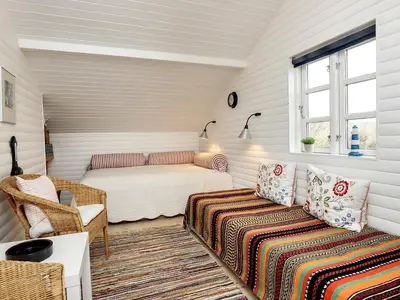 a bedroom with a bed and a couch in a room at 5 person holiday home in Brovst-By Traum in Brovst