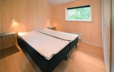 a large bed in a room with a window at Holiday Home Hjerm Gh-1983 in Hjerm
