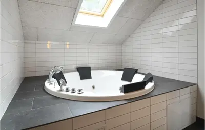 a bath tub in a bathroom with a skylight at Holiday Home Hjerm Gh-1983 in Hjerm
