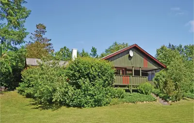 a house with a yard with bushes in front of it at Holiday Home Farsø Qr-1965 in Farsø