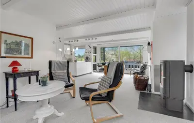 a kitchen and living room with a table and chairs at Holiday Home Farsø Qr-1965 in Farsø