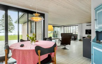 a kitchen and dining room with a table and chairs at Awesome Home In Roslev With Kitchen in Roslev